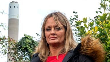 Mandy Royle stands in front of the Runcorn incinerator, which backs onto her property