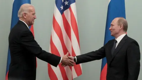 Reuters Russian Prime Minister Putin shakes hands with US Vice-President Biden during their meeting in Moscow, March 2011