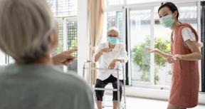 Elderly women are talking and maintaining a safe distance. Thailand. Photo credit: Shutterstock/CGN089