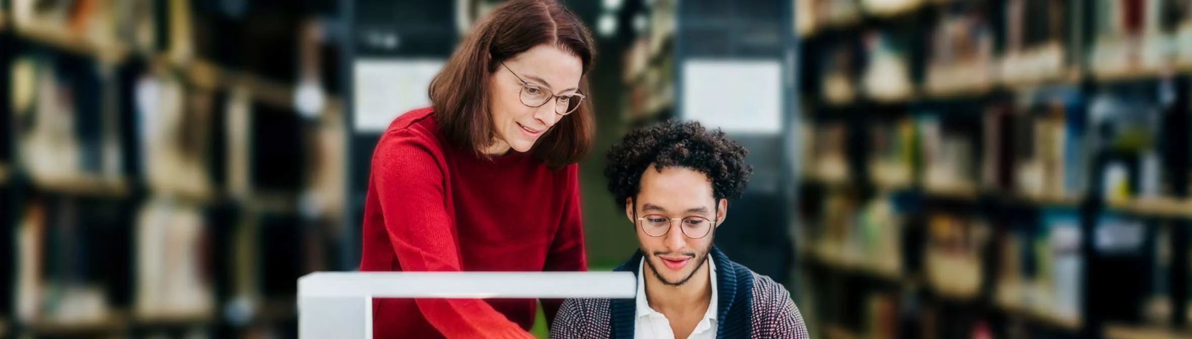 Librarian helping student