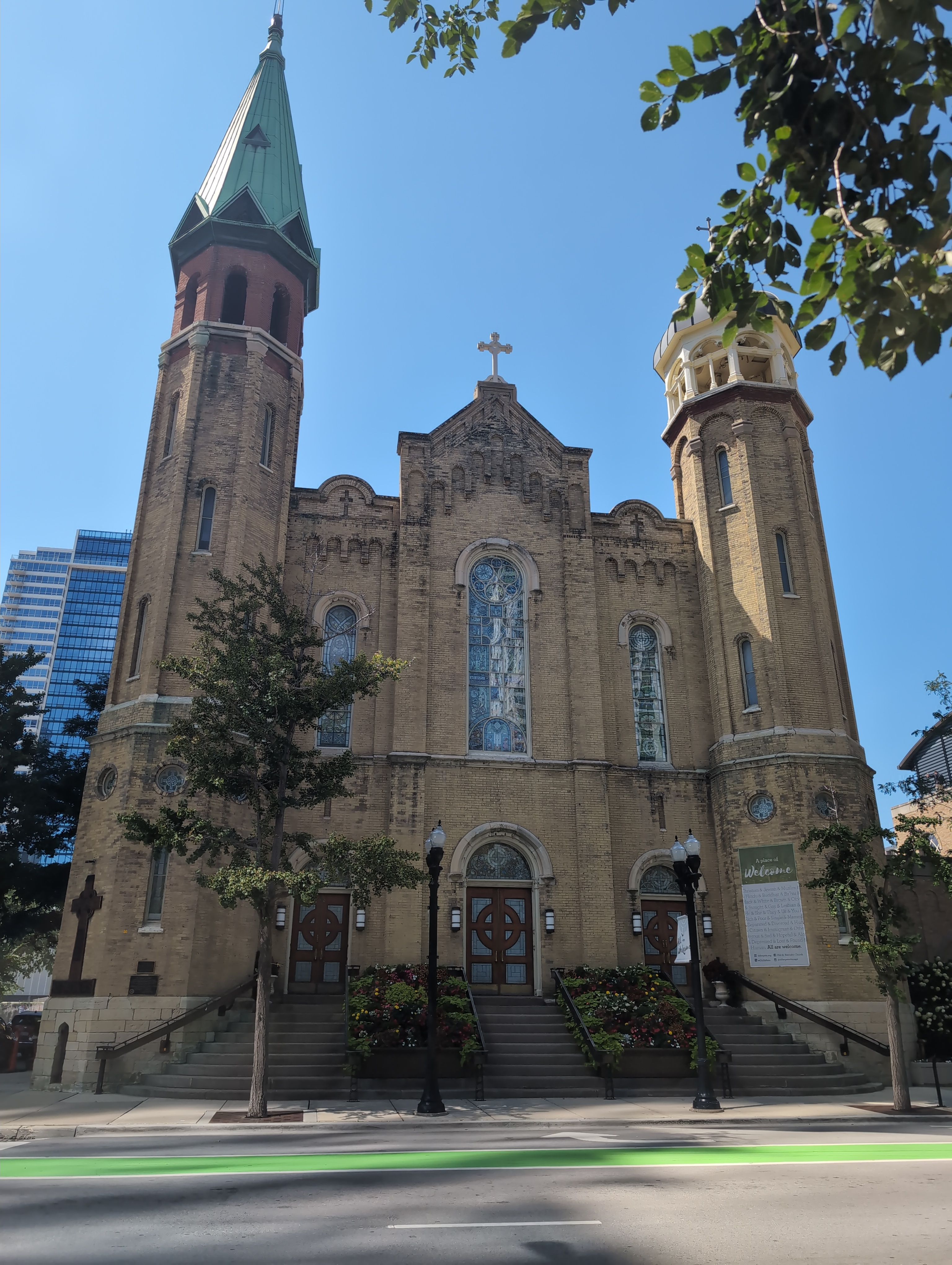 an old Catholic church on the other side of the road, with three closed doors. It is Old St. Patrick's Church in Chicago, Illinois