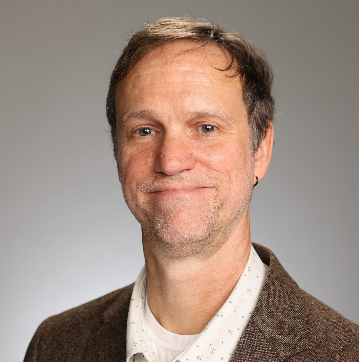 Headshot of Dr. François G. F. Smith against a grey background
