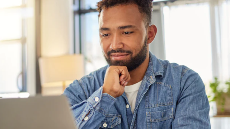 Person working on laptop at home.