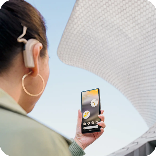 Person with a cochlear implant holds Android phone in front of them.