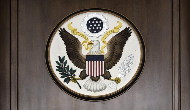 Seal of the United States of America on a dark wooden wall