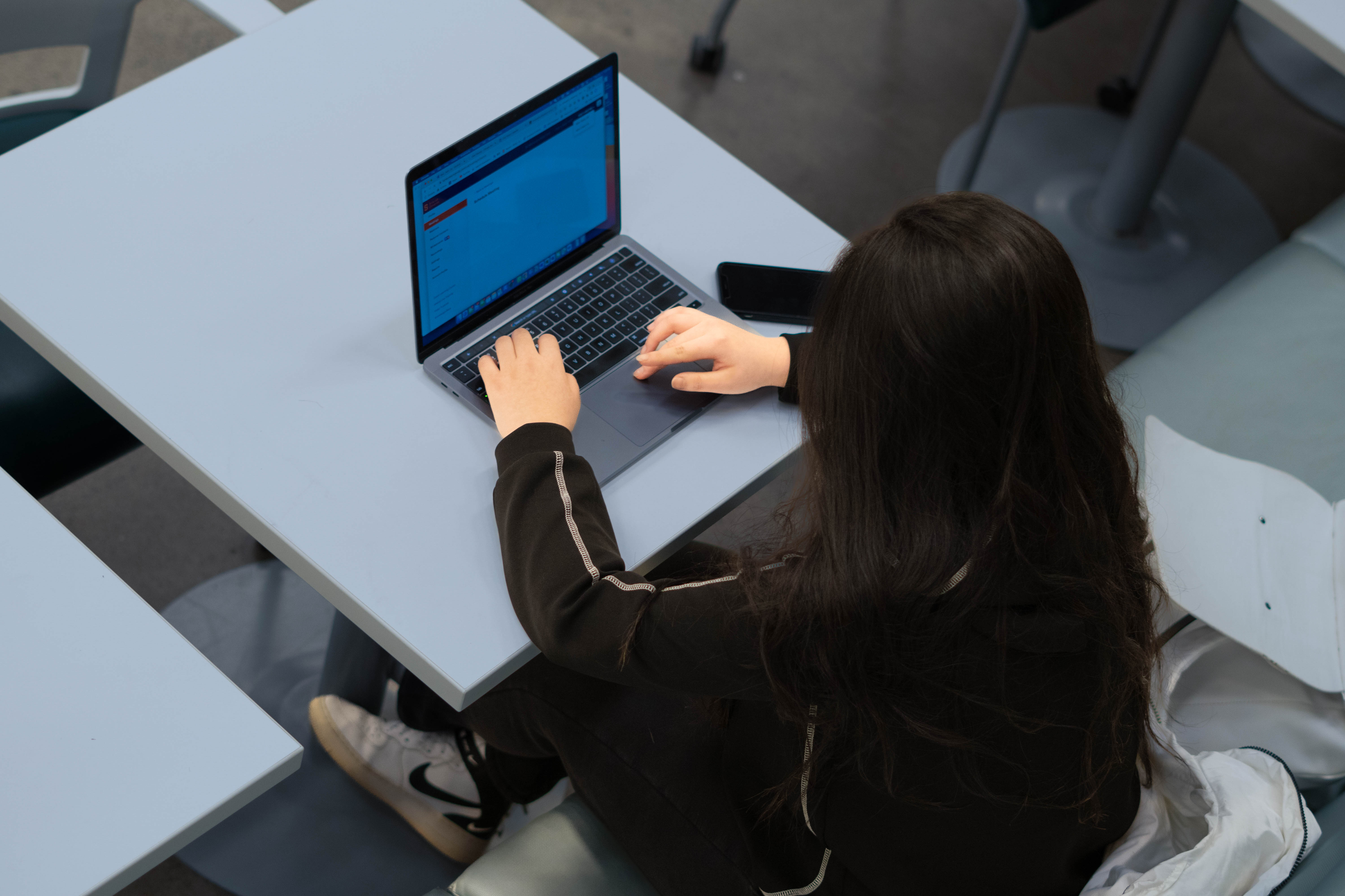 student working on a laptop pc