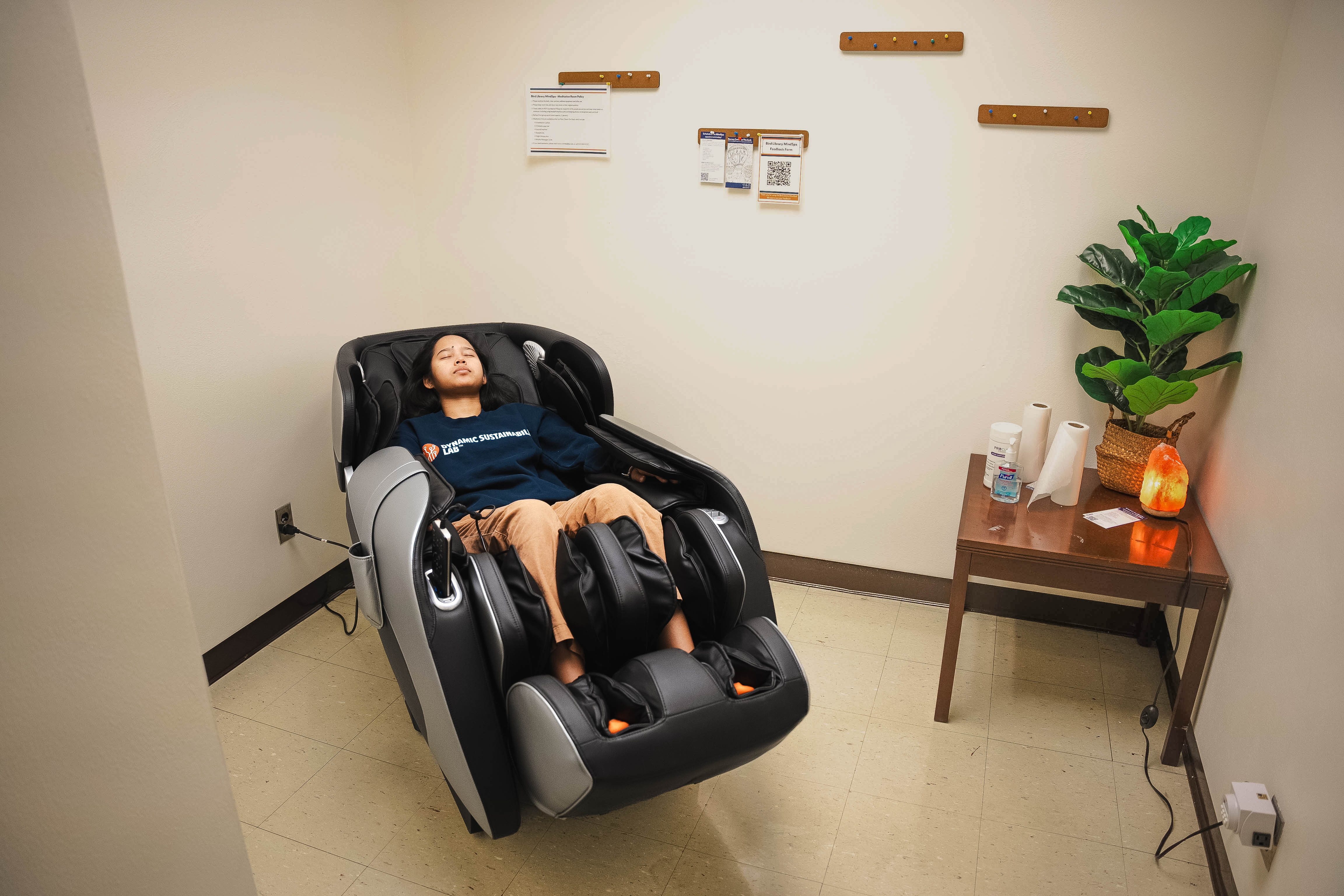 student sitting in massage chair