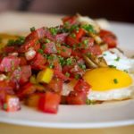 Fried egg topped with fresh salsa