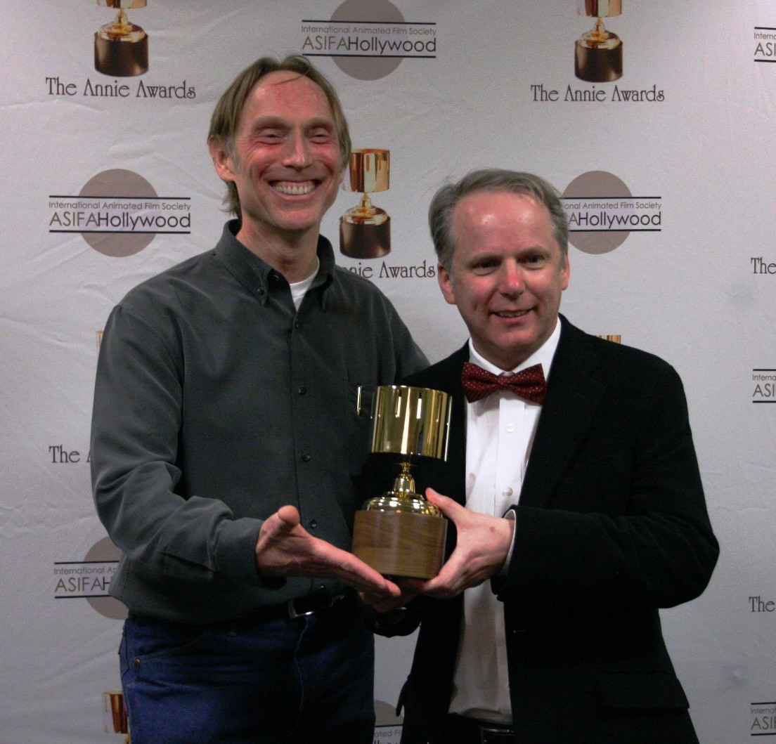 Presenter Henry Selick congratulates Nick Park on his Ub Iwerks award