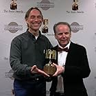 Presenter Henry Selick congratulates Nick Park on his Ub Iwerks award