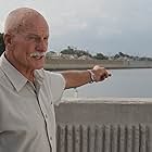 Soil expert Dr. Robert Bea of the University of California, Berkley, points to a repaired levee breach on the 17th Street canal in New Orleans.