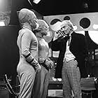 William Hartnell as Dr Who, peers through his monocle at two extra-terrestrials during filming of the popular science fiction series, 'Dr Who' at the BBC's Shepherds Bush Studios in London. 