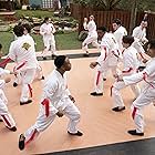 Nathaniel Oh, Oona O'Brien, Mary Mouser, Jacob Bertrand, Tanner Buchanan, Gianni DeCenzo, Xolo Maridueña, Dallas Dupree Young, and Khalil Everage in Cobra Kai (2018)