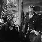 George Sanders and Gene Lockhart in A Scandal in Paris (1946)