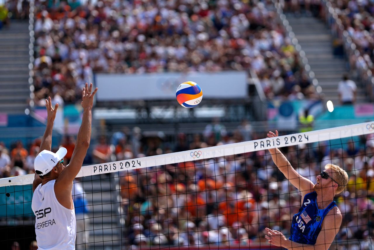 United States' Chase Budinger, right, hits across the net towards Spain's Pablo Herrera Allepuz in a beach volleyball match on August 2.