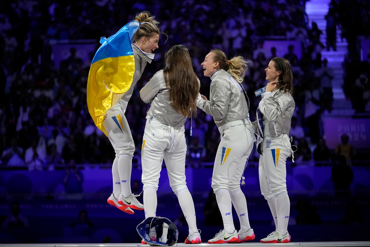 Ukraine's Olga Kharlan, left, celebrates with her teammates after winning the women's team sabre final match on August 3.