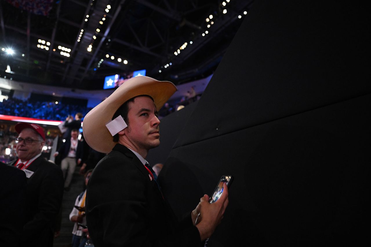 Brian Bodine of Texas attends the 2024 Republican National Convention. He's wearing a bandage, as some other attendees did, to mark the bandage worn by former President Trump after the assassination attempt last week.