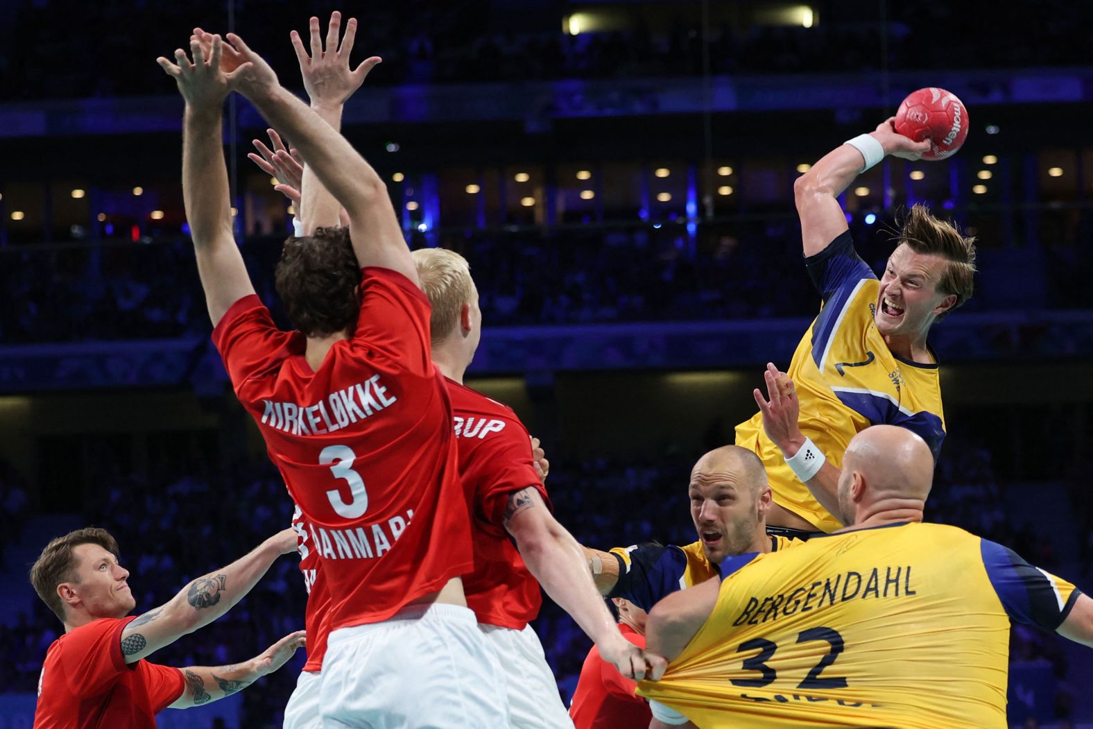 Sweden's Jonathan Carlsbogård jumps to shoot during a handball quarterfinal against Denmark on August 7.