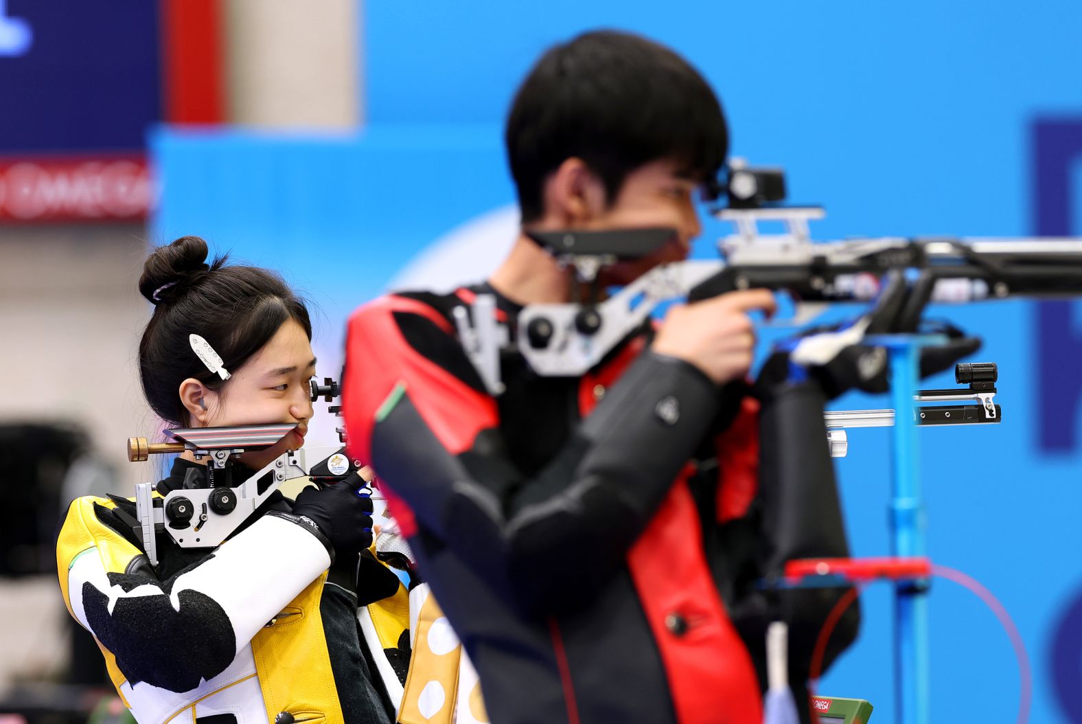 China’s Huang Yuting, left, competes in the 10-meter air rifle mixed-team shooting competition with Sheng Lihao on July 27. <a href="https://www.cnn.com/sport/live-news/paris-olympics-news-2024-07-27#h_93b948f94523253e5a87b1f0890e07ed"