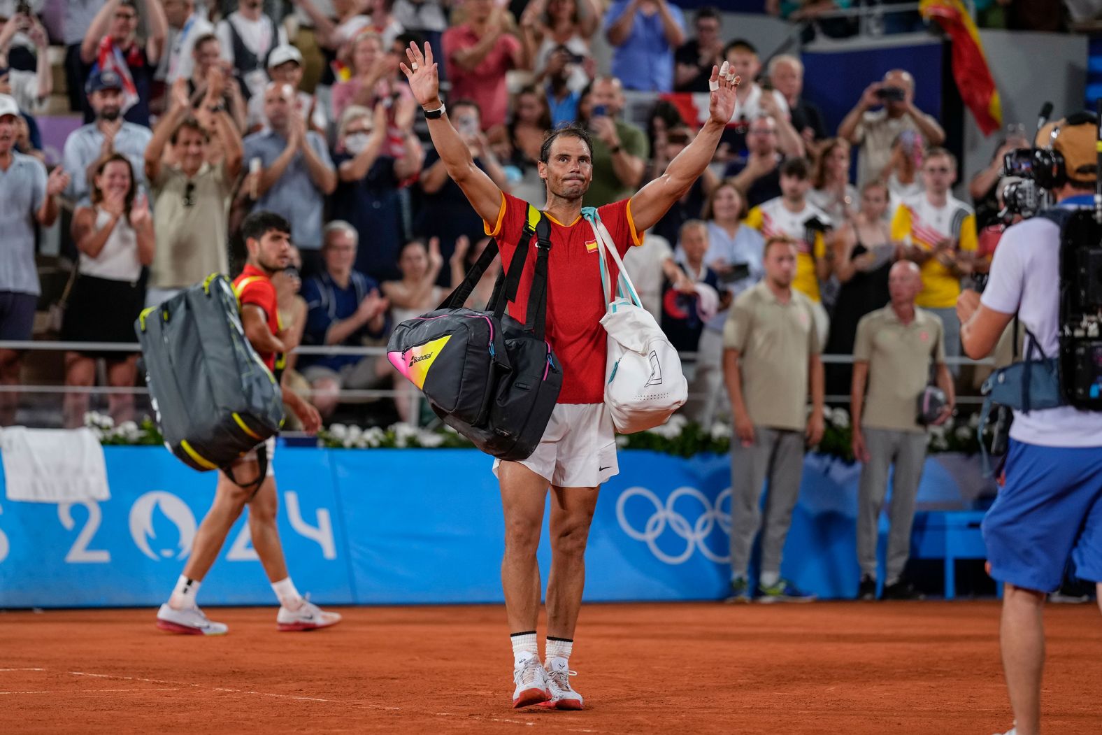 Spain's Rafael Nadal waves goodbye after he and doubles partner Carlos Alcaraz <a href="https://www.cnn.com/sport/live-news/paris-olympics-news-2024-07-31#h_0a2640ae0ab3dcdd672021796d4f2c1b"