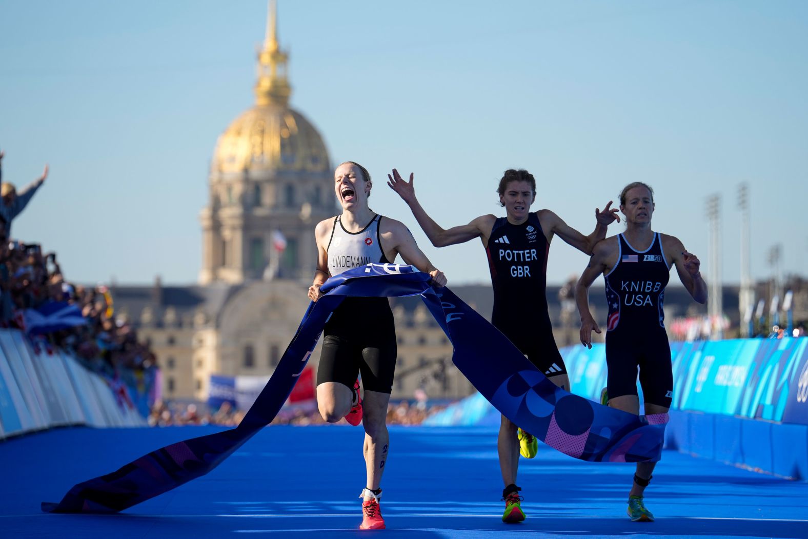 Triathlete Laura Lindemann, left, celebrates after she crossed the finish line <a href="https://www.cnn.com/sport/live-news/paris-olympics-news-2024-08-05#h_1daac4b41669abd11d80548ac2296483"