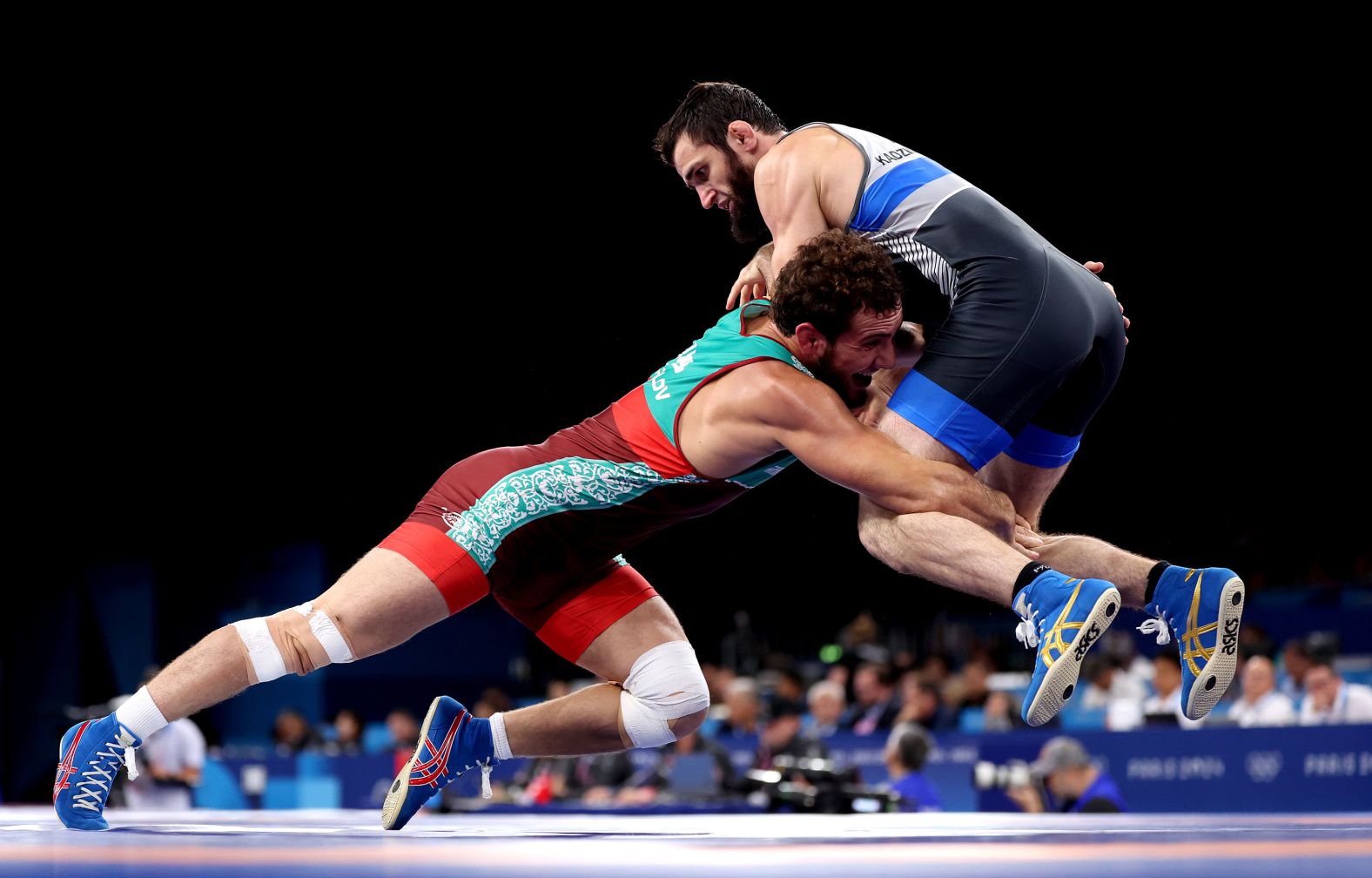 Uzbekistan's Razambek Zhamalov, left, wrestles Mahamedkhabib Kadzimahamedau, a member of the neutral athletes team, on August 9. Amid the <a href="https://www.cnn.com/world/europe/ukraine"