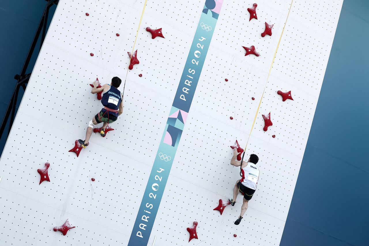 Amir Maimuratov of Kazakhstan, left, and Reza Alipour Shenazandifard of Iran in action at Le Bourget Sport Climbing Venue on August 6.