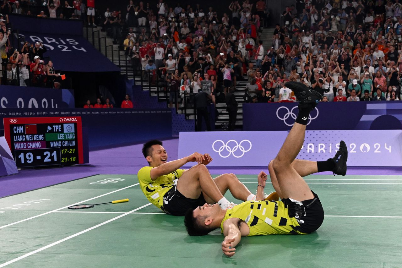 Taiwan's Lee Yang and Wang Chi-lin celebrate after winning the doubles badminton final against China on August 4.