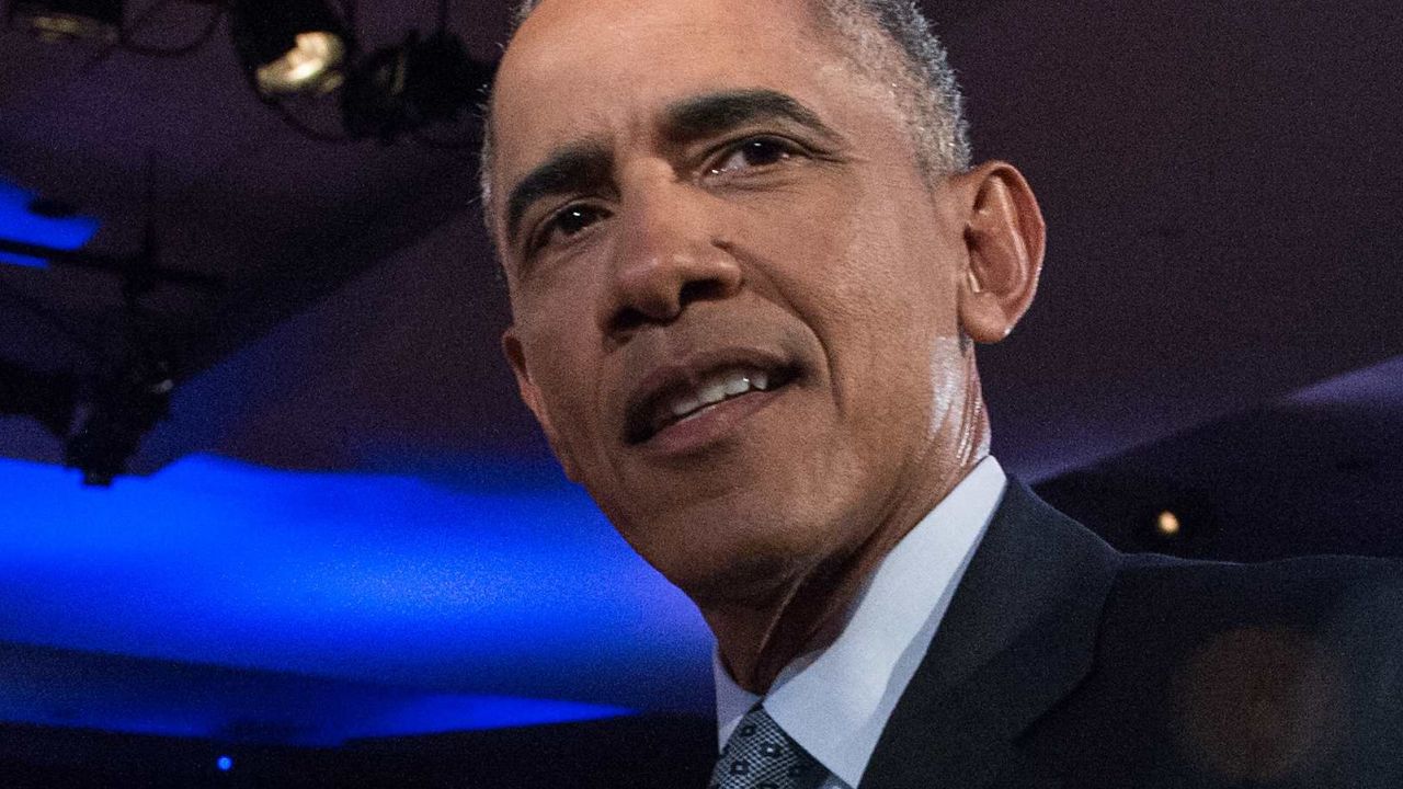 US President Barack Obama walks to greet Taya Kyle, widow of Navy Seal Chris Kyle, made famous by the film "American Sniper," during a commercial break at a town hall meeting with CNN's Anderson Cooper on reducing gun violence at George Mason University in Fairfax, Virginia, on January 7, 2016. Obama announced limited measures two days ago to tackle rampant US gun violence and called on Americans to punish lawmakers who oppose more meaningful reforms.   AFP PHOTO/NICHOLAS KAMM / AFP / NICHOLAS KAMM        (Photo credit should read NICHOLAS KAMM/AFP/Getty Images)