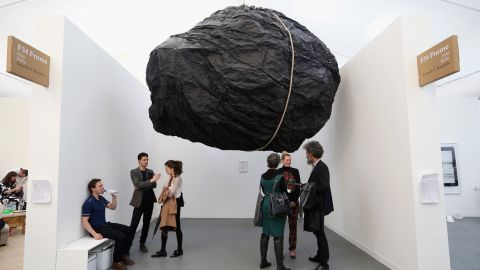 Members of the public admire Eduardo Basualdo's artwork 'TEORIA' at the Frieze London art fair on October 16, 2013 in London, England. The annual Frieze Art Fair takes place in London's Regent's Park and runs from October 17 to 20. The exhibition comprises of the Frieze Masters exhibition and Frieze London which aim to showcase historic and established art as well as contemporary works.