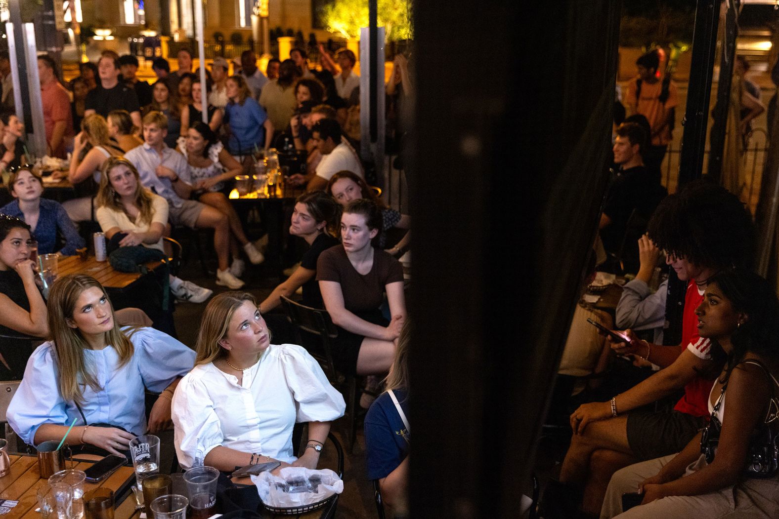 People watch the CNN presidential debate from Union Pub in Washington, DC.