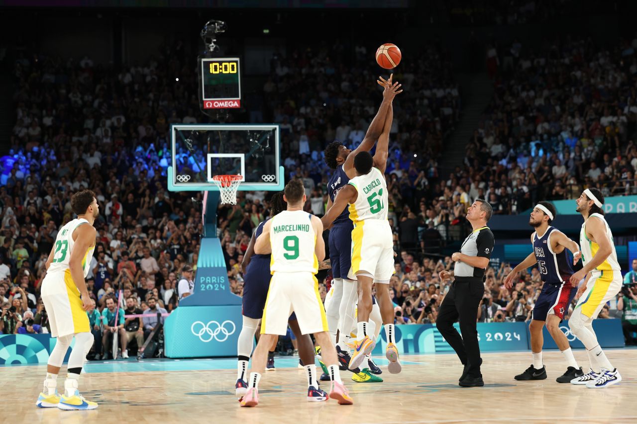 Joel Embiid of team USA and Bruno Caboclo of team Brazil contest for the opening tip off during a men's basketball game in Paris, on August 6.