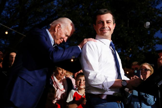 Biden puts his hands on the shoulders of Pete Buttigieg as Buttigieg <a href="https://www.cnn.com/2020/03/02/politics/pete-buttigieg-endorsement-obama-biden-calls/index.html" target="_blank"