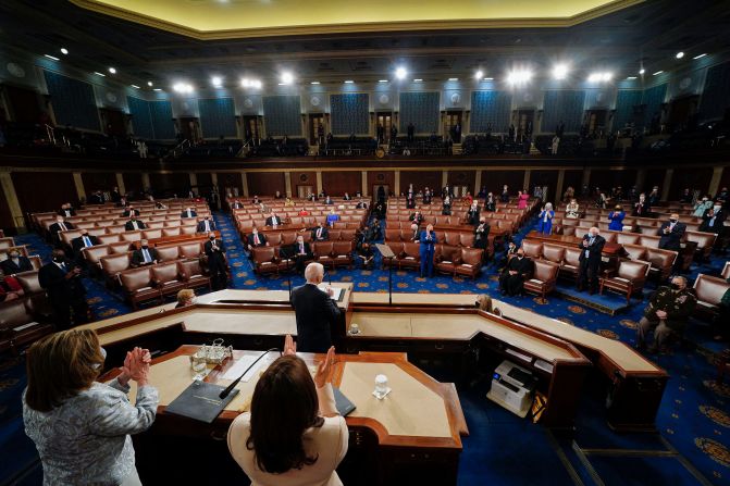 Biden addresses a joint session of Congress in April 2021. Because of Covid-19 restrictions, only a limited number of lawmakers were in the House chamber. <a href="https://www.cnn.com/2021/04/28/politics/gallery/biden-first-address-joint-session-congress/index.html" target="_blank"