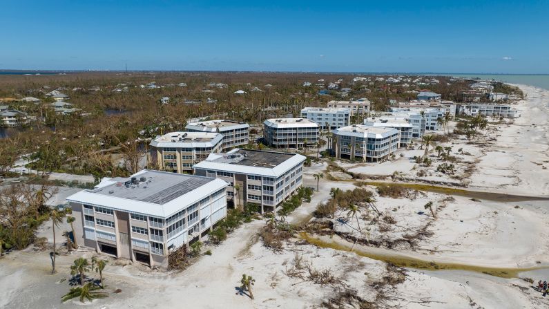 Water streams past buildings on the oceanfront on Sanibel Island, Florida, on Friday.