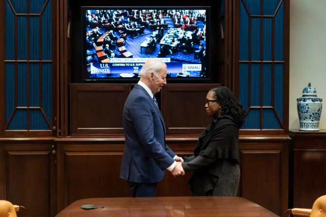 Biden holds hands with <a href="https://www.cnn.com/2022/02/25/politics/gallery/ketanji-brown-jackson/index.html" target="_blank"