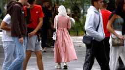 A Muslim woman, wearing the style of dress called an abaya, walks in a street in Nantes, France, August 29, 2023. REUTERS/Stephane Mahe