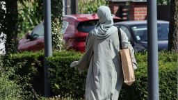 A woman wearing an abaya dress walks through the streets of Lille, northern France, on August 28, 2023. The French government's decision to ban schoolgirls wearing abayas -- long, flowing dresses of Middle Eastern origin -- has opened a fresh debate about the country's secular laws and the treatment of Muslim minorities. (Photo by Denis Charlet / AFP) (Photo by DENIS CHARLET/AFP via Getty Images)