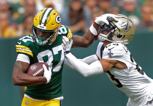 Green Bay Packers wide receiver Romeo Doubs fends off New Orleans Saints cornerback Isaac Yiadom during the first half at Lambeau Field on September 24. The Packers edged out a 18-17 win. 