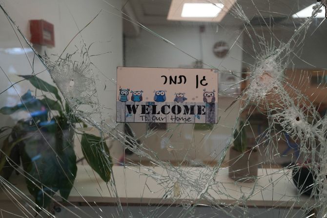 Bullet holes are seen in a cracked window at the entrance of a kindergarten in Be'eri, Israel, on October 11. The self-sustaining farming community near Gaza was <a href="https://www.cnn.com/2023/10/10/middleeast/israel-beeri-bodies-found-idf-intl-hnk/index.html" target="_blank"