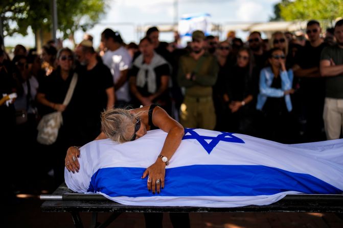 Antonio Macías' mother cries over her son's body at Pardes Haim cemetery in Kfar Saba, Israel, on October 15. Macías was killed by Hamas at an <a href="https://www.cnn.com/2023/10/07/middleeast/israel-gaza-fighting-hamas-attack-music-festival-intl-hnk/index.html" target="_blank"