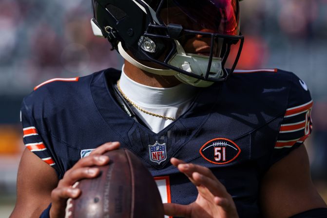 Chicago Bears quarterback Justin Fields warms up wearing a #51 patch honoring the late <a href="https://www.cnn.com/2023/10/05/sport/dick-butkus-death-illinois-bears/index.html" target="_blank"