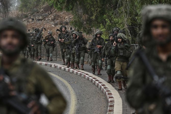 Israeli army soldiers patrol at an undisclosed position in northern Israel near the border with Lebanon on October 15.