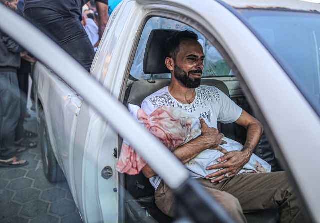 Relatives mourn as bodies are carried for burial from Al Aqsa Martyrs Hospital in Deir Al-Balah, Gaza, on October 31.