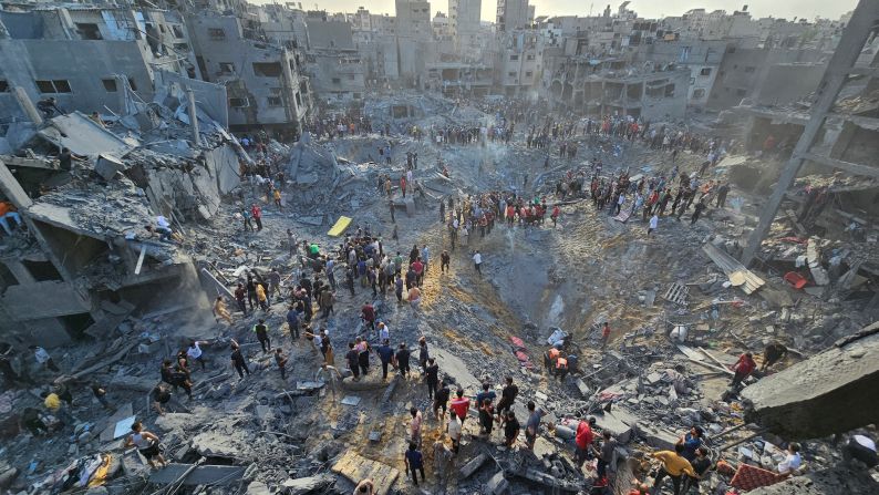 Palestinians search for casualties at the site of Israeli strikes on Jabalya refugee camp in northern Gaza on October 31. 