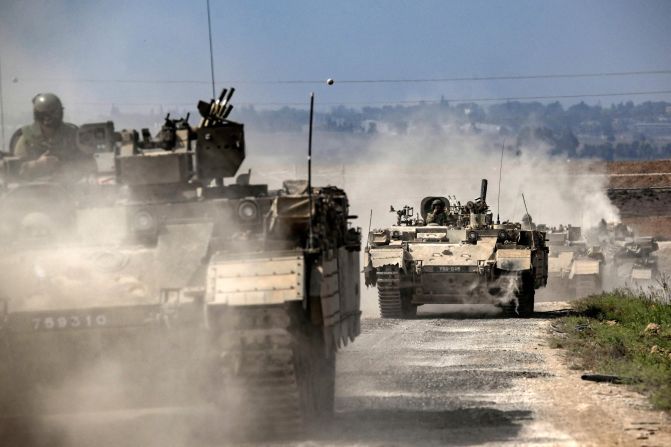 Israeli army Puma armored personnel carriers  move in a column near the Gaza border in southern Israel on October 14.