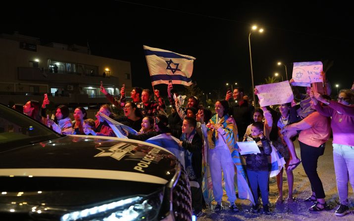 People welcome a convoy carrying newly released hostages in Ofakim, Israel, on Sunday, November 26.