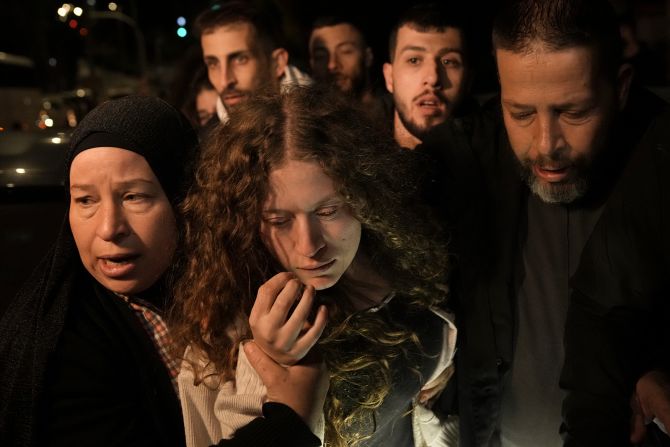 Palestinian activist Ahed Tamimi, walks with her mother after she was released from prison by Israel, in Ramallah in the Israeli-occupied West Bank, on early November 30.