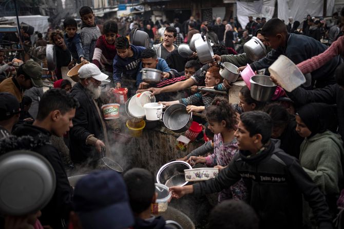 Palestinians converge for a free meal in Rafah, Gaza, on December 21.