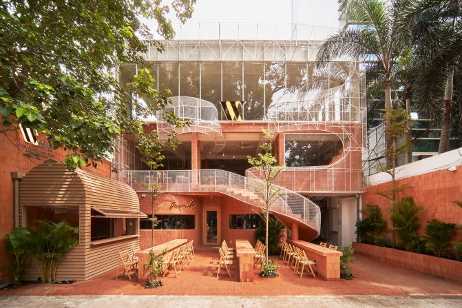 Anh Coffee Roastery in Ho Chi Minh City, Vietnam. The storefront was inspired by the basalt-red volcanic soil found in Vietnam's Central Highlands region, the country's main coffee-growing district.